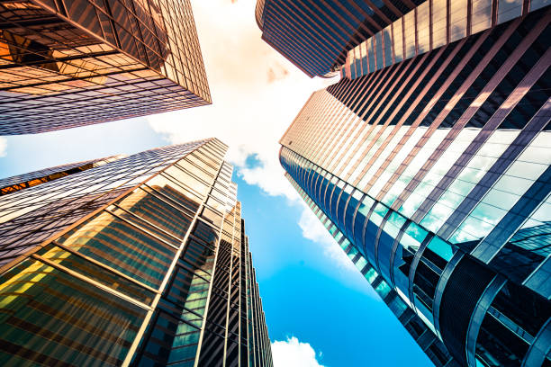 istock Looking up a reflections on glass covered corporate building 1348328415