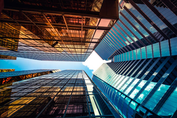 istock Looking up a reflections on glass covered corporate building 1348328423