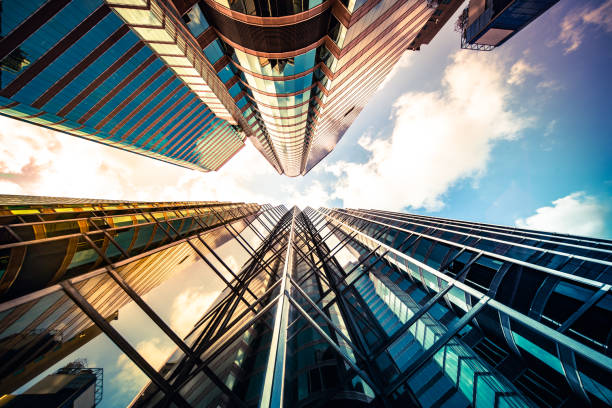 istock Looking up a reflections on glass covered corporate building 1348328434