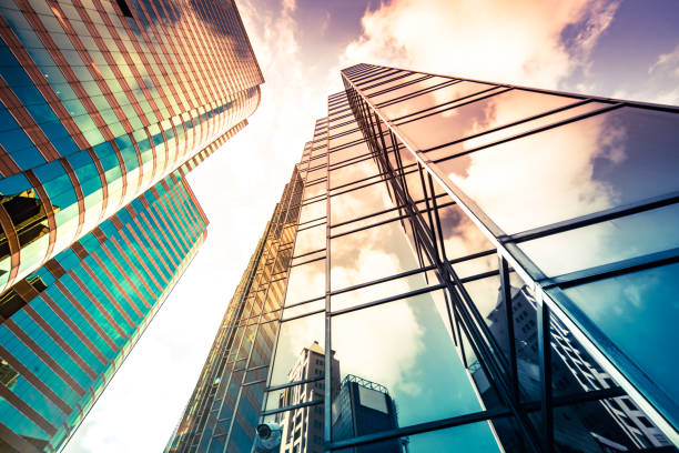 istock Looking up a reflections on glass covered corporate building 1348328459
