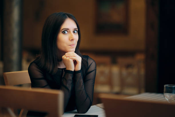 istock Funny Young Woman Waiting in a Restaurant 1348330745
