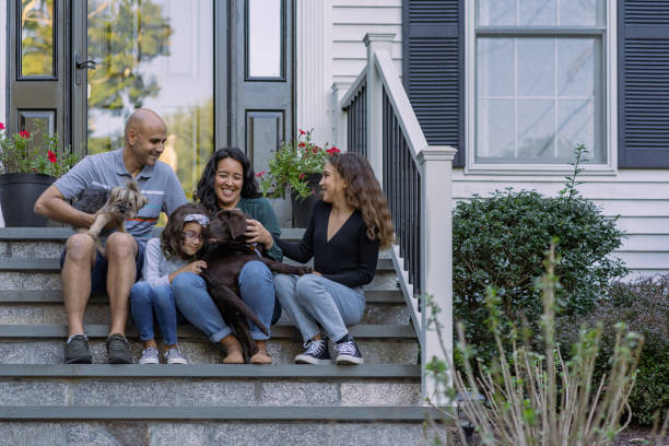 family in front of their house - asian ethnicity child four people couple imagens e fotografias de stock