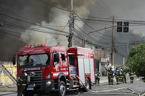 firefighters extinguishing a fire in a shed on Dom Pedro avenue, Ipiranga district, in Sao Paulo, Brazil.