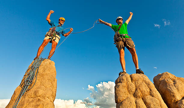 istock Rock climbing team reaching the summit. 134834139