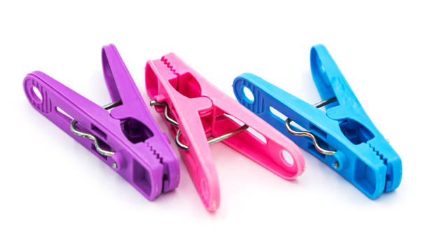 istock Colorful plastic clothespins or clothes pegs isolated on white background 1348346909