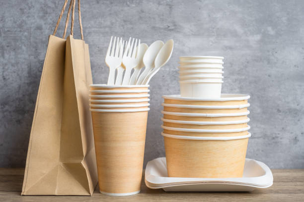 istock Eco friendly food packaging on table background. natural container: cup, plate, spoon and fork. zero waste, pollution, earth day, free plastic, world Environment day concept 1348347539