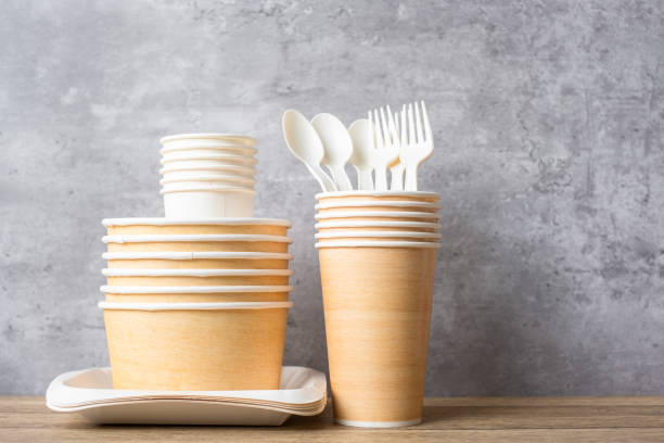 istock Eco friendly food packaging on table background. natural container: cup, plate, spoon and fork. zero waste, pollution, earth day, free plastic, world Environment day concept 1348347541