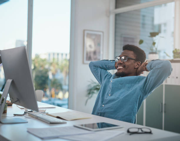 istock Shot of a young businessman taking a break after using a computer in a modern office 1348347591