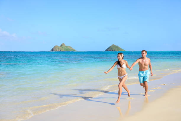 istock Beach travel happy vacations couple running 1348350098