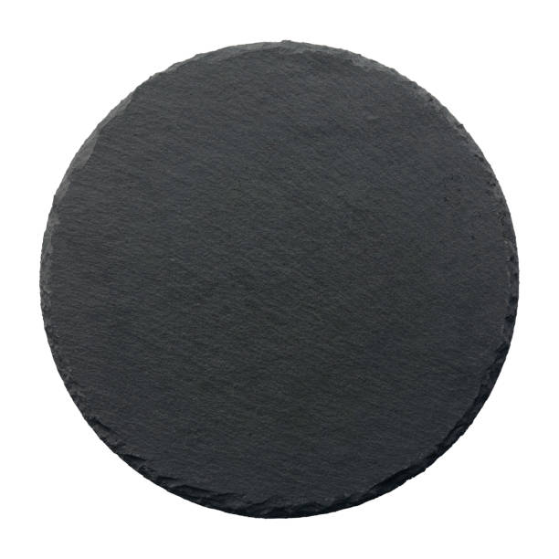istock Top view of black slate round stone isolated on white background. 1348350118