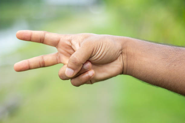 istock Showing a man's hand and his two fingers and blurring the background behind it 1348350256