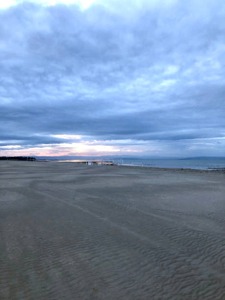 istock Dark clouds over beach on Adriatic coast at Grado, Italy 1348352743
