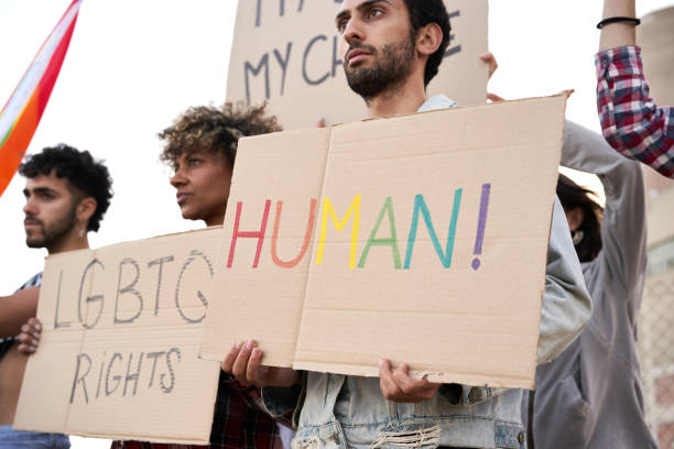 istock Activists protesting discrimination holding banners, LGBT community. 1348352759