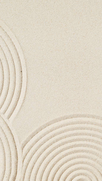 istock Lines drawing on sand, beautiful sandy texture. Spa background, minimal concept 1348355382