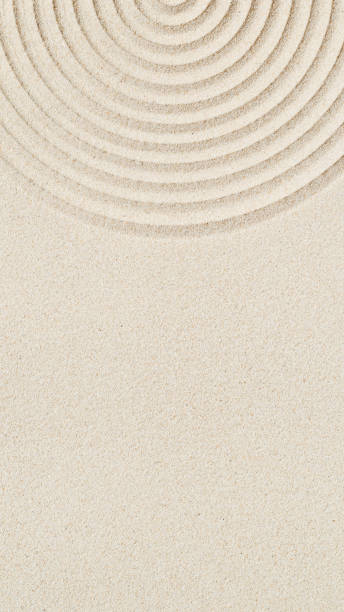 istock Lines drawing on sand, beautiful sandy texture. Spa background, minimal concept 1348355384