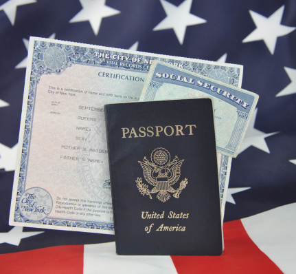 American Identification Papers Passport Social Security Card New York Birth Certificate on American Flag Background