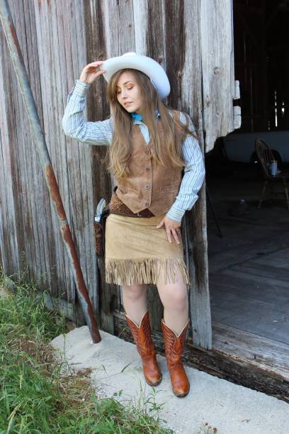 istock American Cowgirl in a barn 1348358348