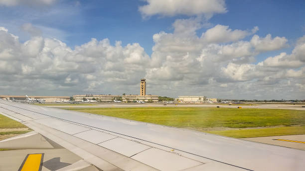 Taxiway Milwaukee, Wisconsin March 25, 2019 Milwaukee, Wisconsin. The airplane sits on the runway. A view of the tower can be seen in the distance. Soon the all clear will be given and the plane will make its way down the runway for takeoff. patient-filing-system stock pictures, royalty-free photos & images