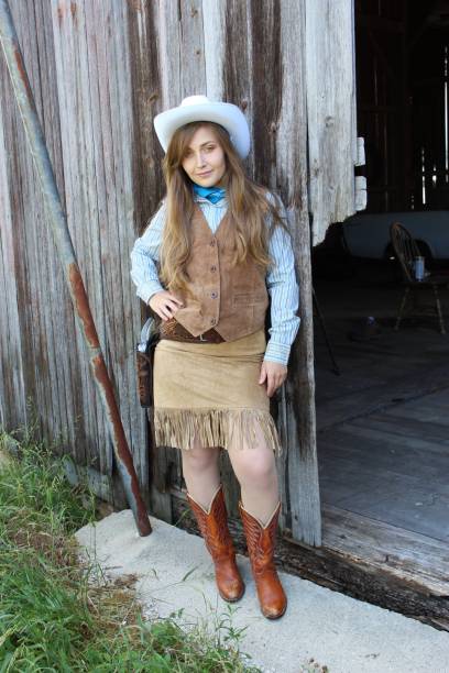 istock American Cowgirl in a barn 1348358410