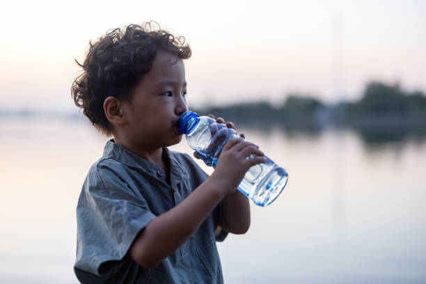 istock The little boy is drinking water 1348359003