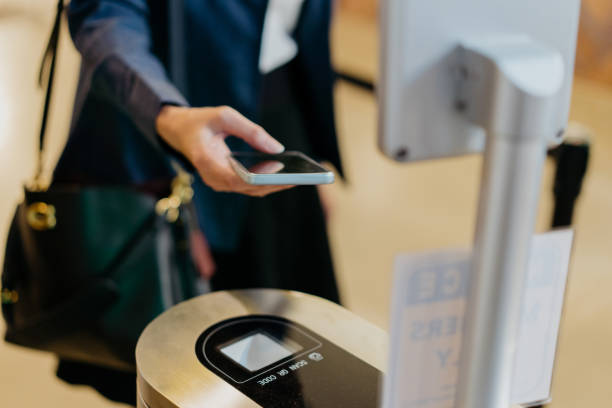 istock Businesswoman scanning QR code on security turnstile 1348360576