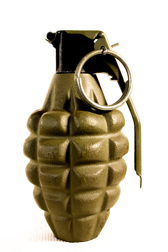 Top of a military hand grenade with pin intact.  White background   MORE LIKE THIS... in lightboxes below.