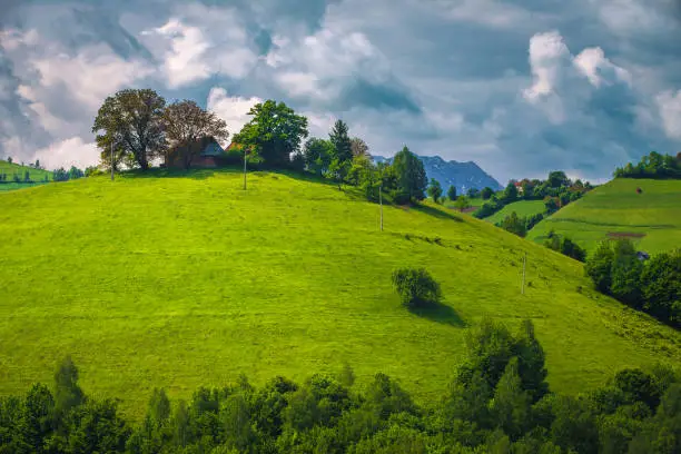 Photo of Stunning spring rural scenery with ranch on the hill, Romania