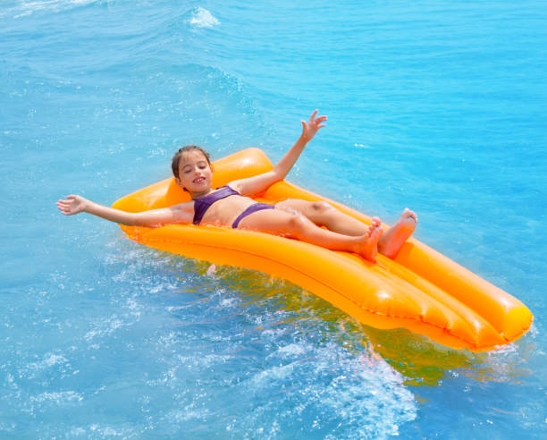 istock children kid girl playing in beach floating lounge 1348368430