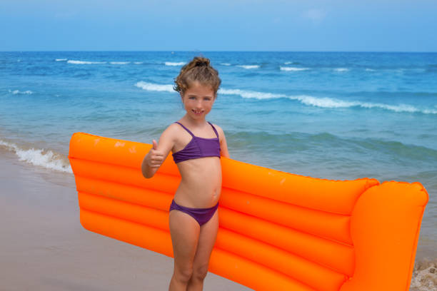 children kid girl playing in beach floating lounge