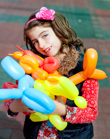 balloon twisting art children happy girl after workshop with many shapes