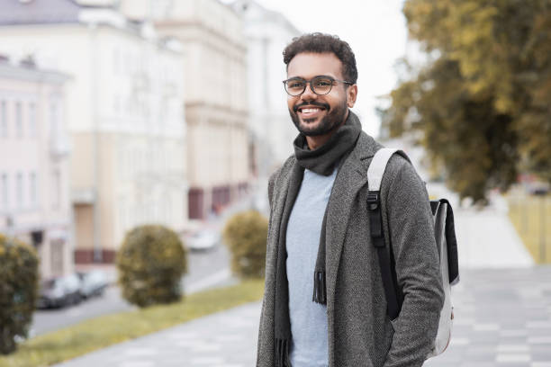 istock Handsome young man wearing warm clothing looking up 1348369731