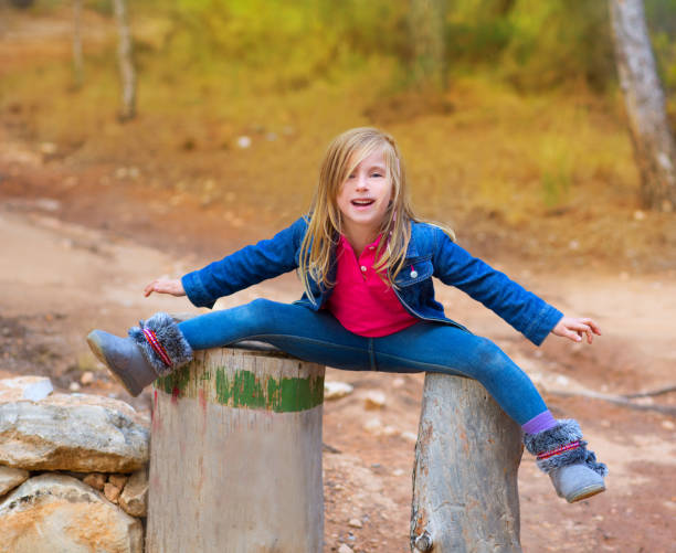 open legs children girl or tree trunks at forest - preschooler autumn beautiful blond hair imagens e fotografias de stock