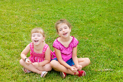 Recommending the books. Small girls giving thumbs up for school activity books. Little children enjoy writing in their note books. Exercise books taking children through the school term comfortably.