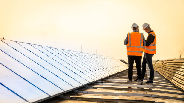 istock Two engineers in reflective clothes inspecting functionality of solar cells in photovoltaic power plant 1348372235