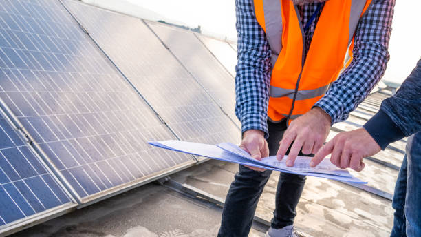 istock Male hands pointing in paper plans, engineers discussing at solar cells 1348372240