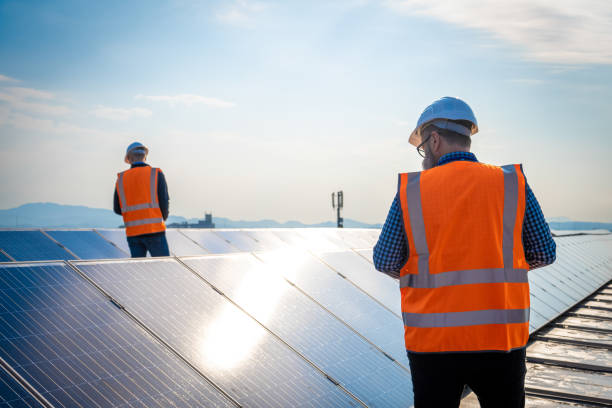 istock Engineers in orange reflective vest checking roof solar power plant 1348372254