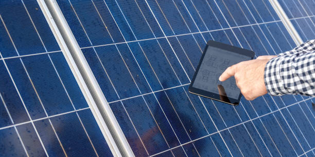 istock Man holding digital tablet and showing electric diagram 1348372255