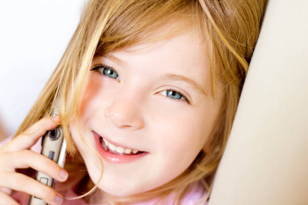 istock Blond child girl talking mobile telephone 1348372445