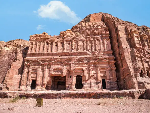 Detail with the ancient burial chambers carved in red sandstone cliffs. Royal tomb facade in the ancient city of Petra, Jordan.