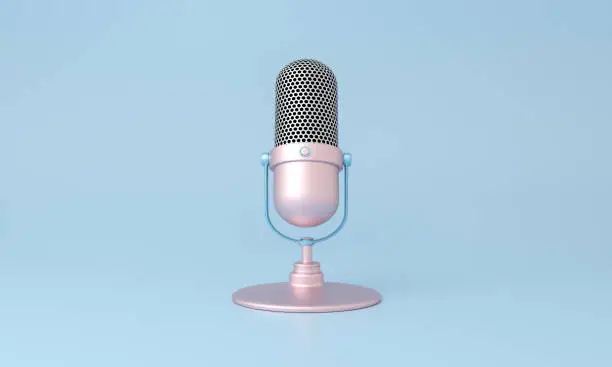 Photo of Cute pink microphone isolated on blue minimal style background.