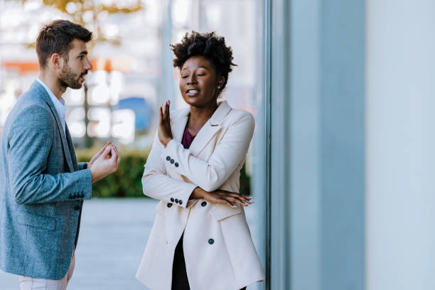 Young mixed-race couple arguing in the city street Sad young black woman and man outdoor on street having relationship problems communication problems stock pictures, royalty-free photos & images