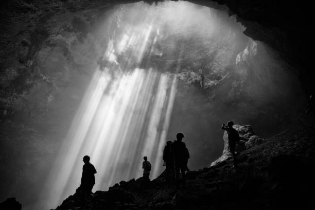 istock Light from the top of Jomblang Cave in Java island, Indonesia (black and white) 1348382483