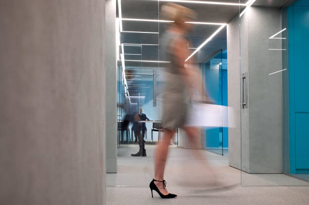 istock Business people walking in the corridor 1348383720
