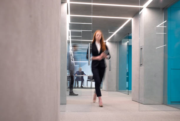 istock Business people walking in the corridor 1348383728