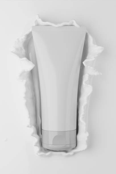 istock Blank white cosmetic tube with cream splash. 1348387191