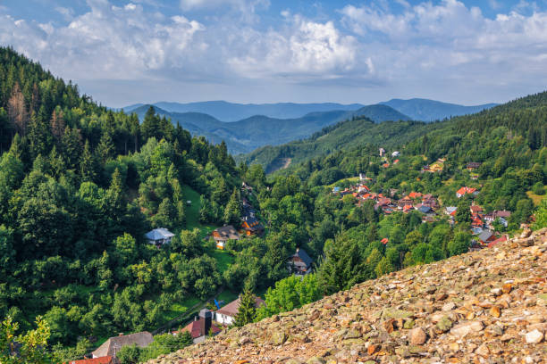 Scenic view of beautiful mountain village - Spania Dolina Scenic view of beautiful mountain village - Spania Dolina in Low Tatras, Slovakia. Small church, colorful house roofs and lush forest. low viewing point stock pictures, royalty-free photos & images