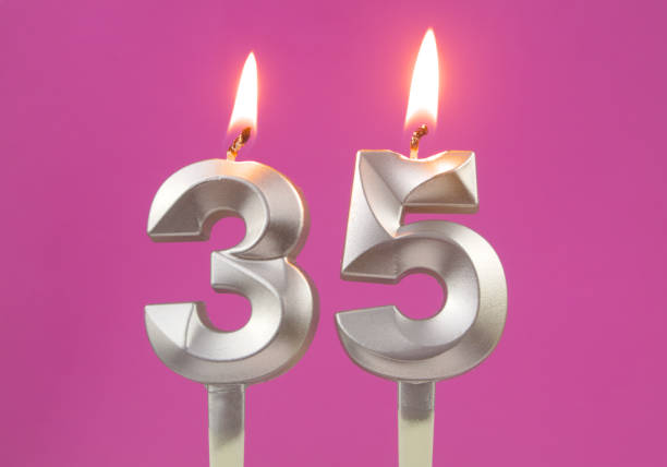 istock Silver birthday candles on pink background, number 35 1348391609