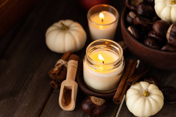 istock Composition with aromatic candles, cinnamon, chestnut. Cozy home atmosphere, aromatherapy. Dark wooden background 1348392596