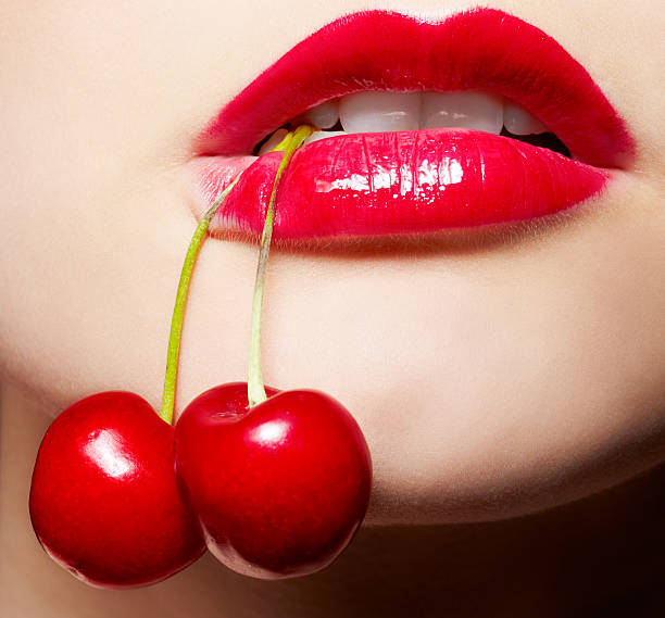 girl with cherry stock photo