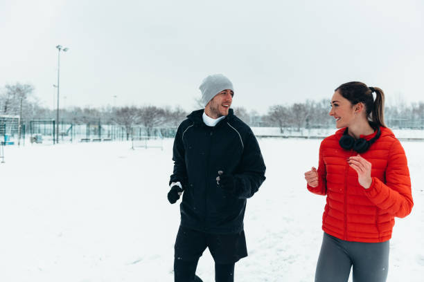 istock Young couple going for a run together during a snow 1348414935